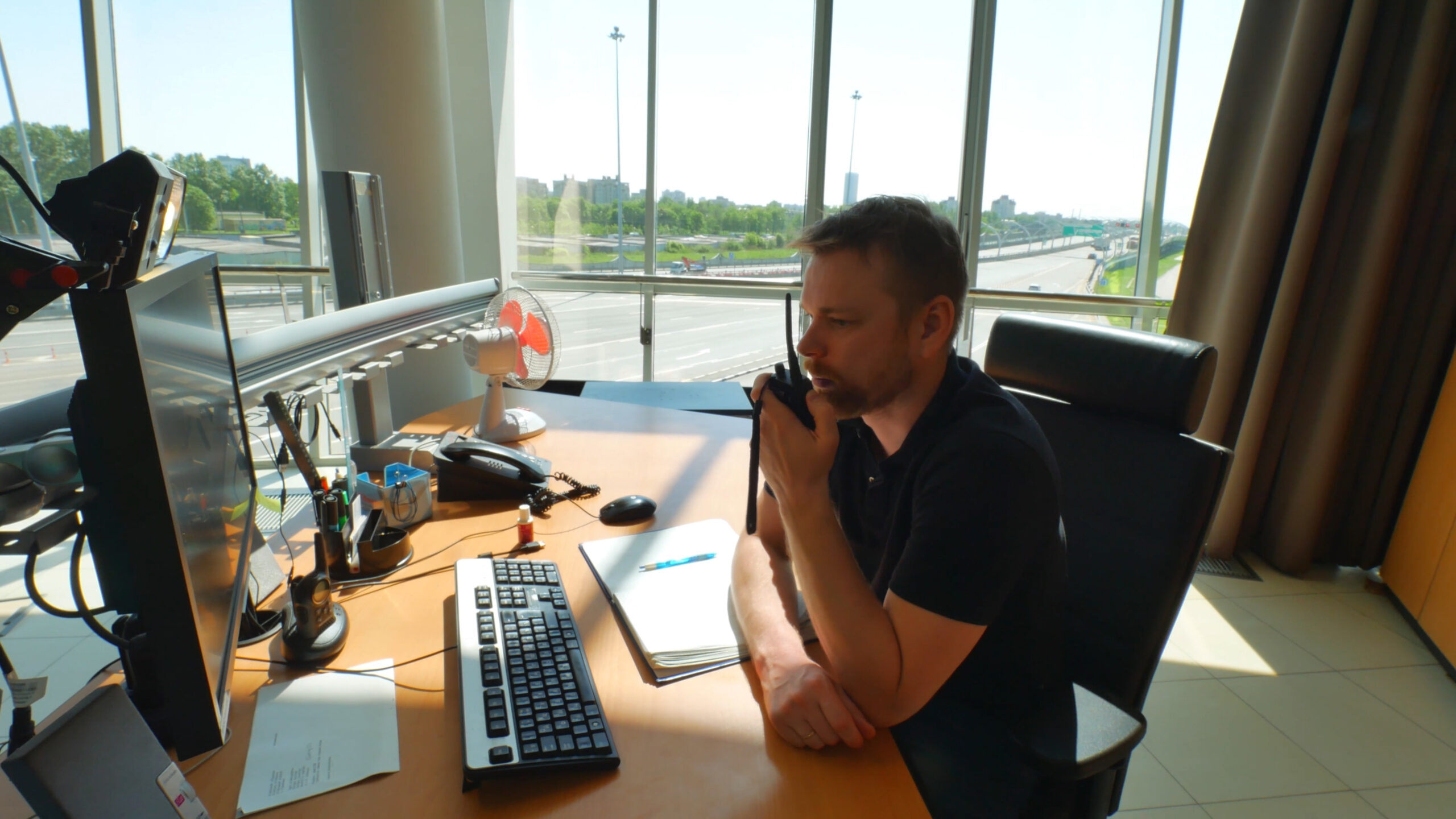 Road,Service,Employee,Using,Walkie,Talkie,And,Computer,Inside,Modern
